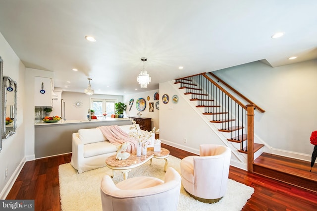 living area featuring recessed lighting, wood finished floors, baseboards, and stairs