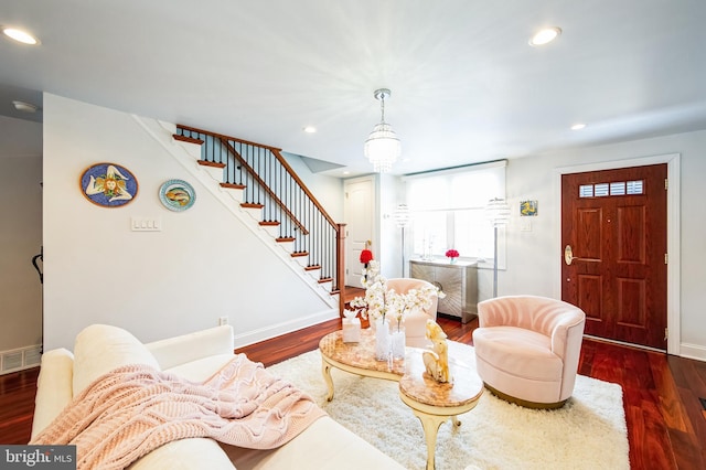 living room with baseboards, visible vents, stairway, wood finished floors, and recessed lighting