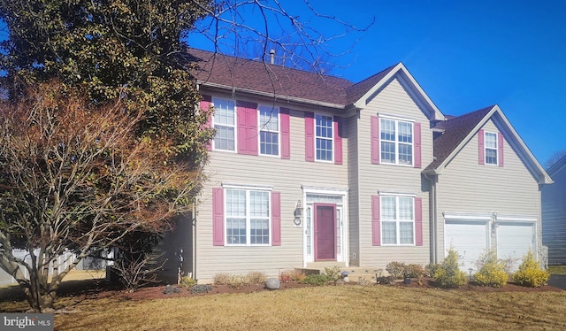 view of front of property with a garage, a shingled roof, and a front lawn