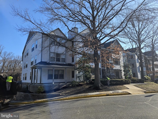 view of front of house featuring a chimney