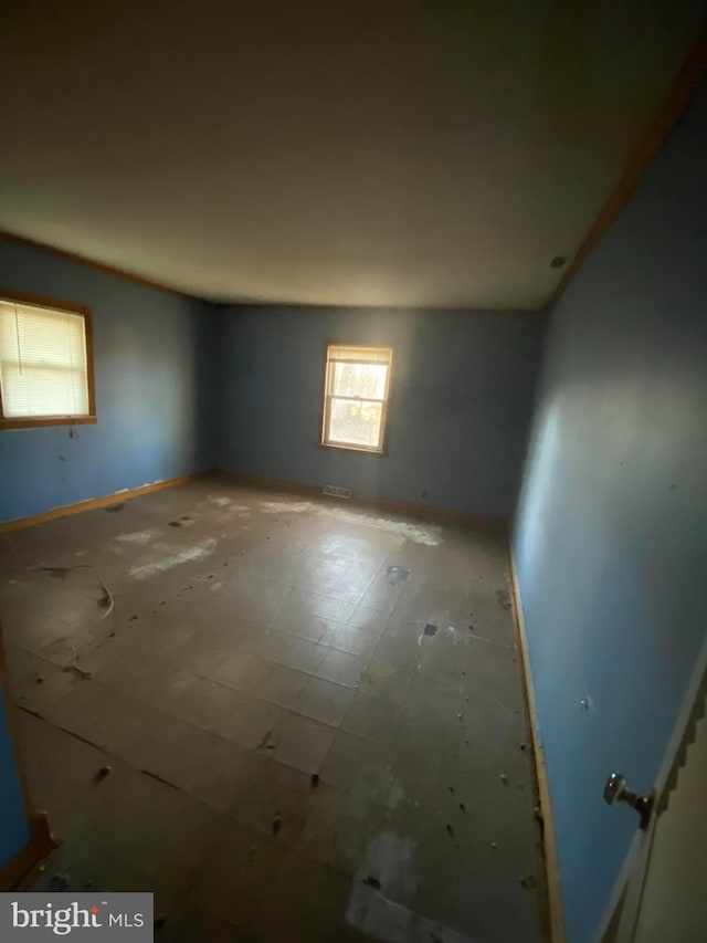 spare room featuring baseboards