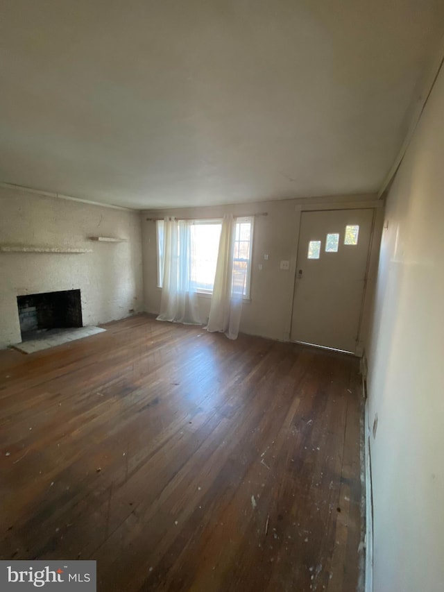 unfurnished living room with a fireplace and hardwood / wood-style flooring
