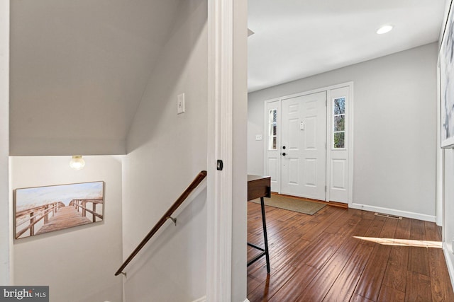 foyer with recessed lighting, wood-type flooring, visible vents, and baseboards