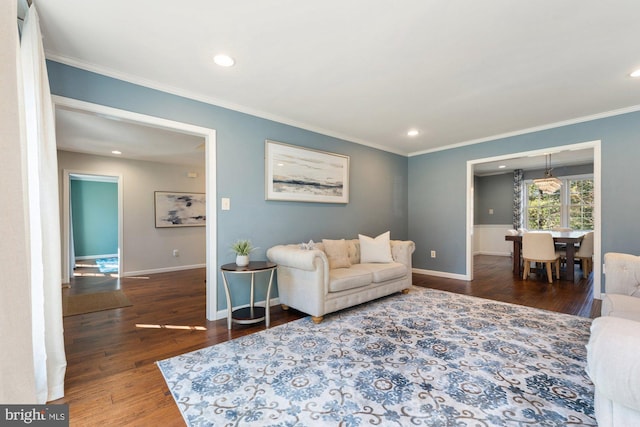 living room with ornamental molding, recessed lighting, baseboards, and wood finished floors