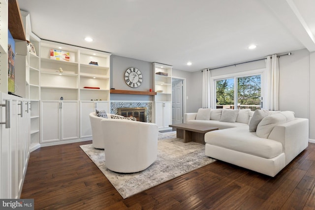 living area with a premium fireplace, dark wood finished floors, and recessed lighting