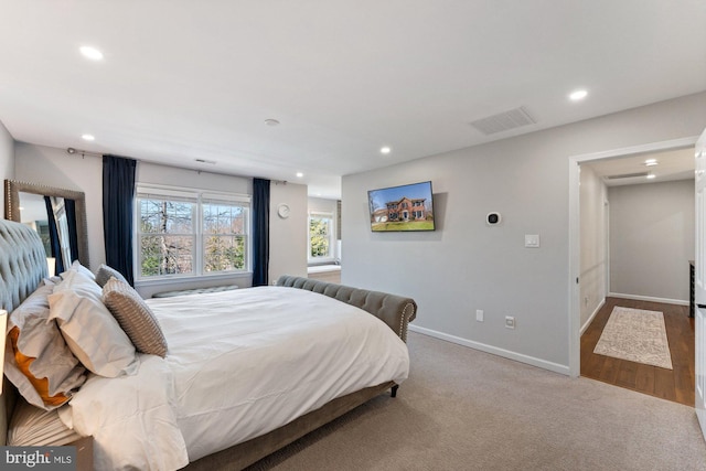 carpeted bedroom featuring baseboards, visible vents, and recessed lighting