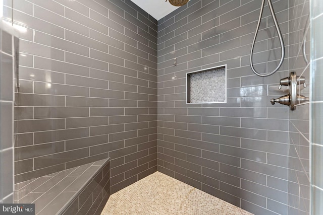 bathroom with a tile shower