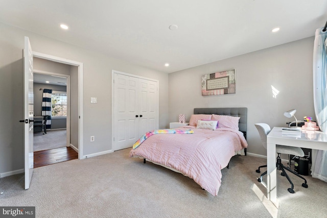 bedroom featuring a closet, recessed lighting, carpet flooring, and baseboards