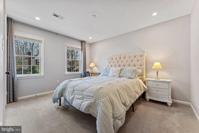 carpeted bedroom featuring recessed lighting, visible vents, and baseboards