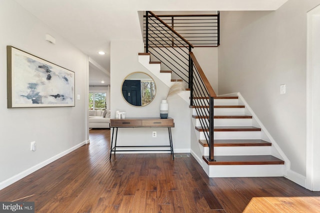 stairs with baseboards, hardwood / wood-style floors, and recessed lighting