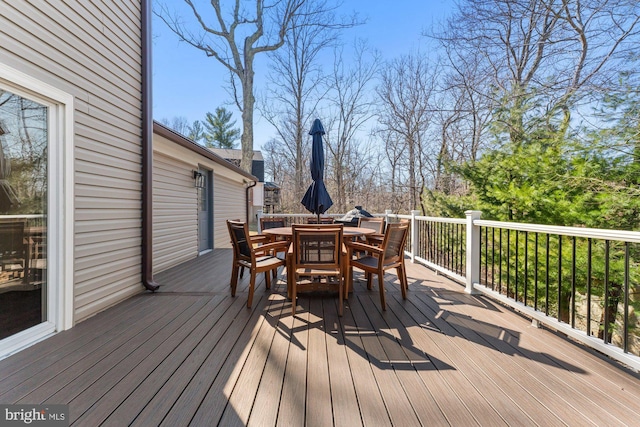 wooden deck featuring outdoor dining area