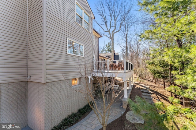 view of side of property with a wooden deck