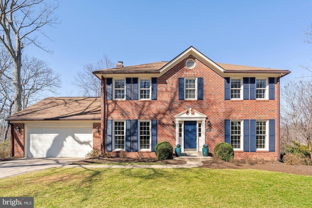 colonial-style house featuring a garage, concrete driveway, brick siding, and a front lawn