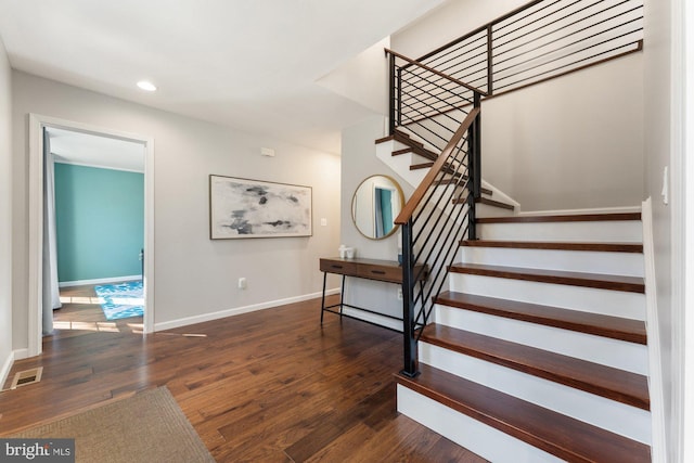 stairs featuring recessed lighting, baseboards, visible vents, and hardwood / wood-style floors