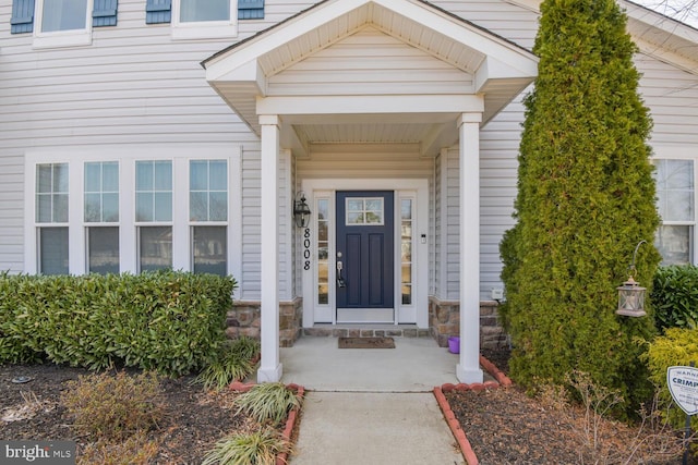 property entrance featuring stone siding