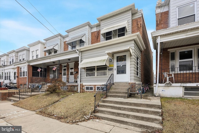 view of property with a residential view and covered porch