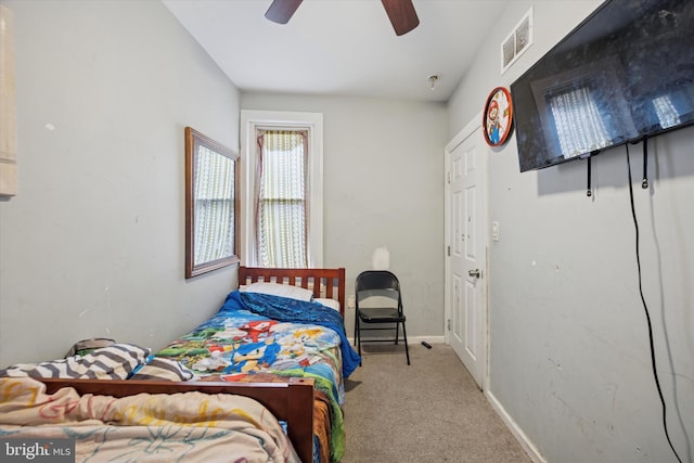 carpeted bedroom featuring a ceiling fan, baseboards, and visible vents