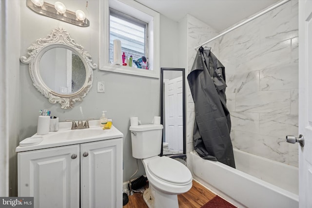 full bath featuring toilet, wood finished floors, vanity, and shower / bath combination with curtain