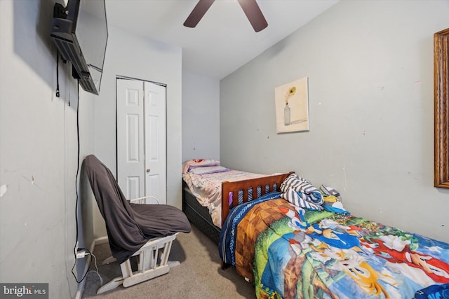 carpeted bedroom with a ceiling fan and a closet