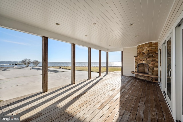 deck featuring a beach view and a water view