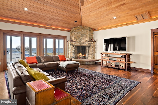 living area featuring vaulted ceiling, hardwood / wood-style flooring, a fireplace, and wood ceiling