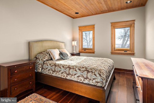 bedroom with dark wood-style floors, wooden ceiling, crown molding, and baseboards