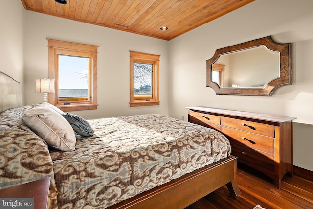 bedroom with dark wood finished floors and wood ceiling