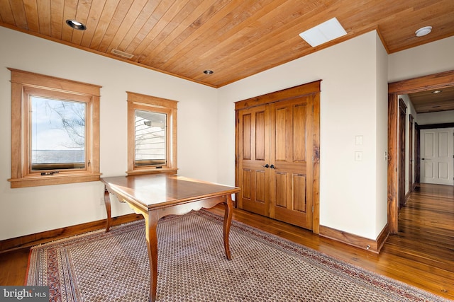 unfurnished office featuring wood ceiling, wood-type flooring, and crown molding