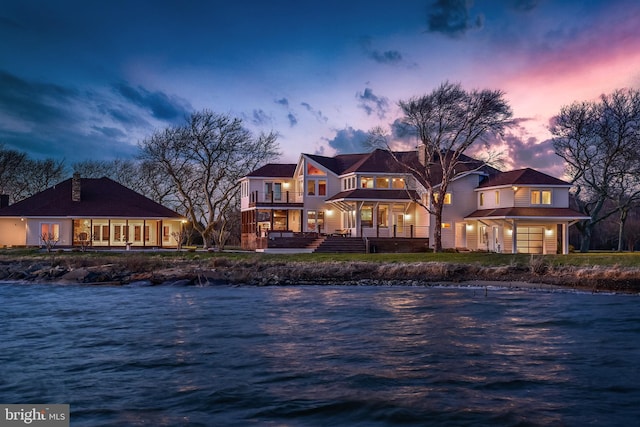 exterior space with a water view and a balcony