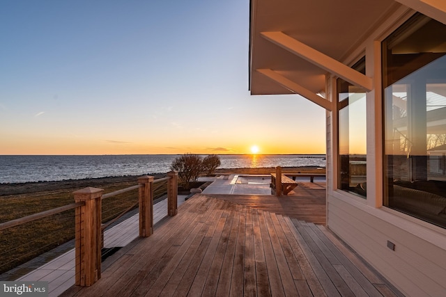 view of dock with a view of the beach and a deck with water view