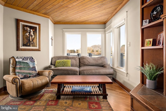 living area featuring wood ceiling, ornamental molding, and light wood-style flooring