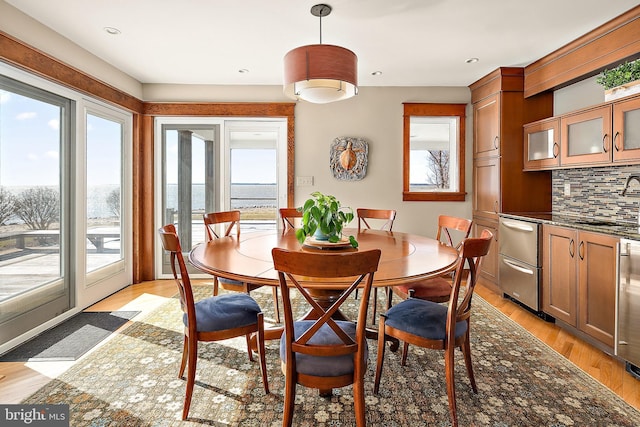 dining room with light wood finished floors and recessed lighting