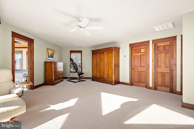 bedroom featuring light colored carpet, ceiling fan, visible vents, and baseboards