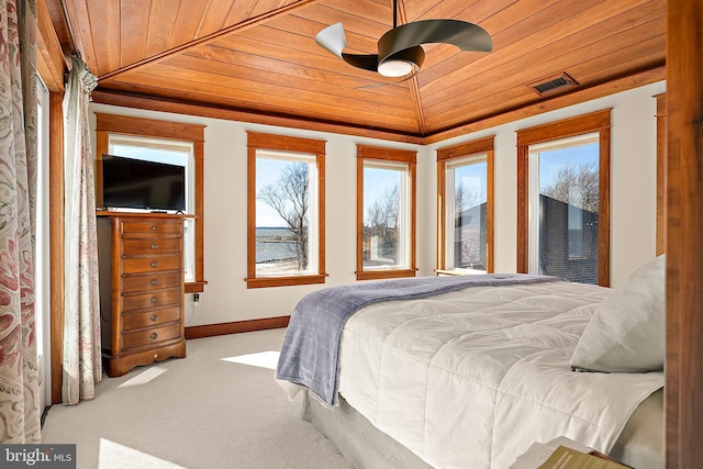 carpeted bedroom featuring lofted ceiling, wood ceiling, visible vents, and baseboards