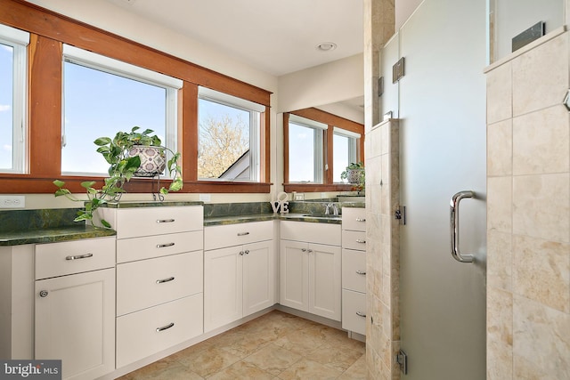 full bathroom with a stall shower and vanity