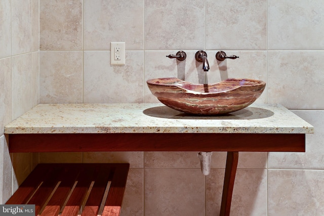 bathroom with backsplash and a sink