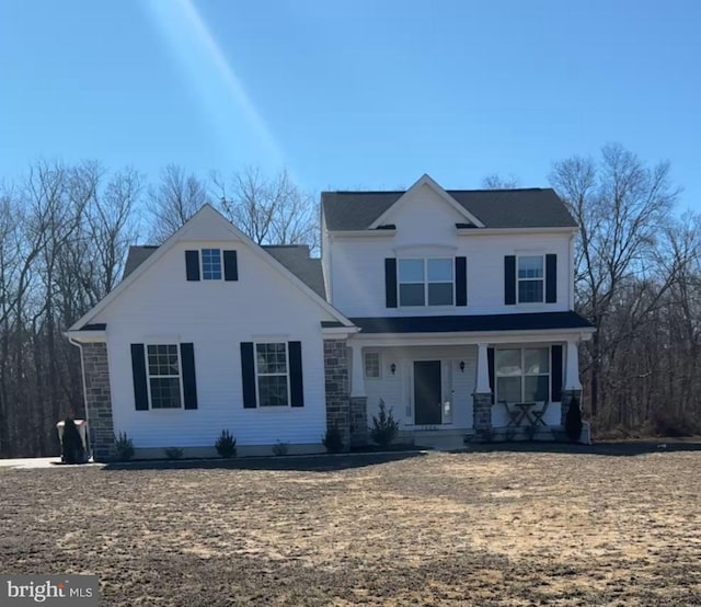 view of front of property with stone siding and covered porch