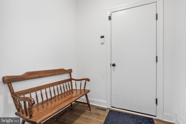 entrance foyer with wood finished floors, visible vents, and baseboards