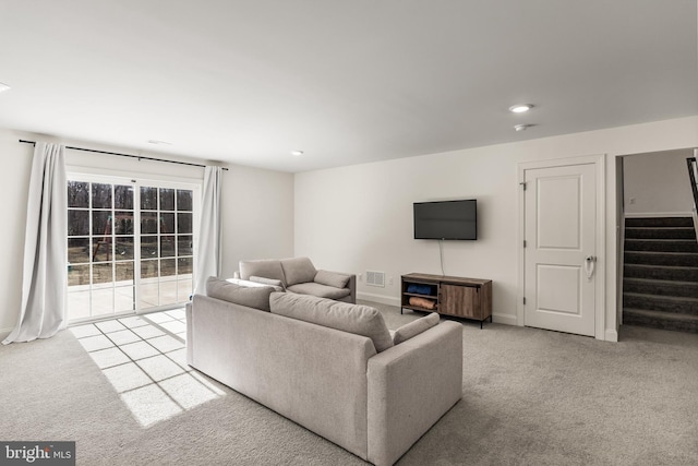 carpeted living area featuring recessed lighting, visible vents, baseboards, and stairs