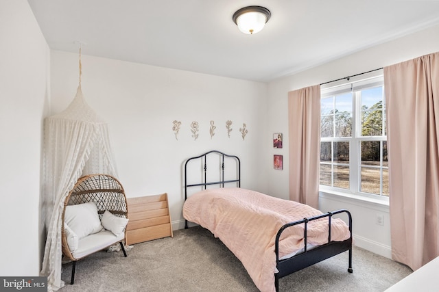 bedroom featuring carpet floors and baseboards