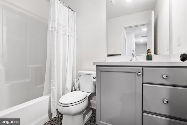 bathroom featuring toilet, shower / tub combo with curtain, and vanity