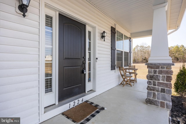 doorway to property featuring covered porch