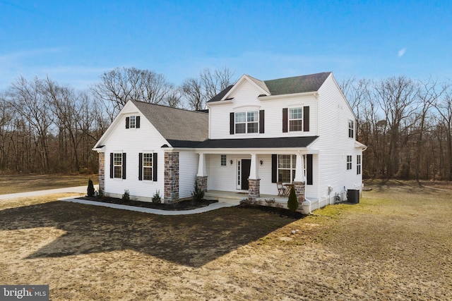 view of front of home featuring a shingled roof, central AC unit, a porch, and a front yard