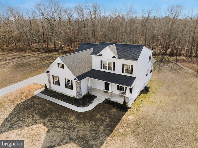 birds eye view of property featuring a wooded view