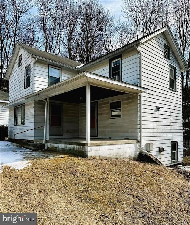 traditional-style home featuring covered porch