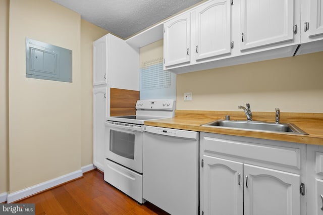 kitchen with dark wood-style floors, white cabinetry, a sink, white appliances, and electric panel