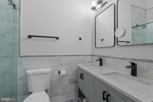 bathroom with a wainscoted wall, a sink, and toilet