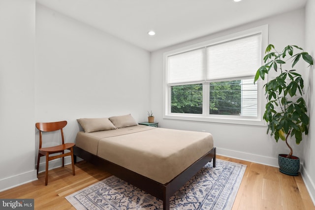 bedroom featuring recessed lighting, wood finished floors, and baseboards