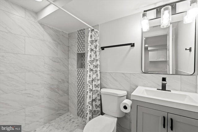 full bath with toilet, tile walls, tiled shower, and vanity