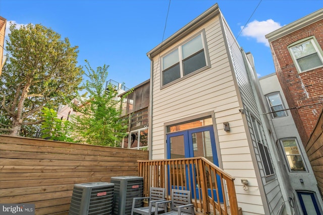 rear view of house featuring central AC unit